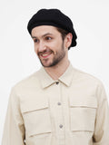 Back view black newsboy cap showing snap button closure and slouchy construction