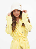 Side profile of beige cloche hat showing flower-shaped bow detail