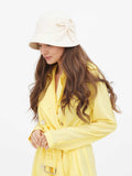 Beige wool cloche hat with hair covering face, three-quarter view