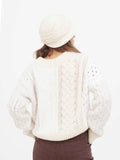Back view of woman wearing beige wool cloche hat, showing crown shape