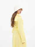 Full-length view of beige cloche hat with yellow dress outfit