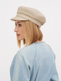 Side profile of beige linen Breton cap showing center button detail on crown