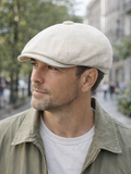 Man wearing beige linen newsboy cap front view summer outdoor