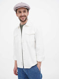 Man wearing beige slouchy newsboy cap with white shirt and blue jeans full body front view