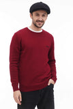 Three quarter view man wearing black newsboy cap with burgundy knit sweater