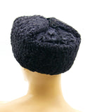Angled black astrakhan fur ushanka earflaps secured