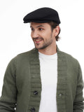 Close-up front view man in black flat cap showing texture with olive bomber jacket
