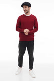 Man wearing black 8-panel newsboy cap standing casual pose burgundy sweater front view