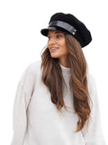 lose-up of woman wearing black cashmere Breton cap showing face framing brim