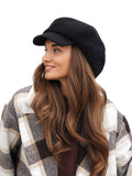 Side face profile of woman wearing black cashmere baker boy cap