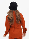 Back view of woman wearing black wool cloche hat, showing long wavy brown hair