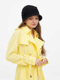 Close-up front view of black wool cloche hat with yellow coat