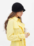 Close-up side view of black cloche hat showing pin-tuck texture