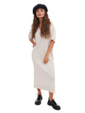 Woman in white midi dress and black boots wearing black cotton newsboy cap full body