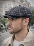 Man wearing black dark plaid linen newsboy cap front view street