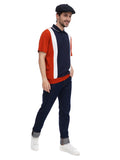 Black baker boy hat styled with colorblock polo casual stance hands in pockets front view