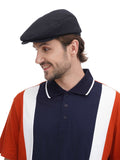 Close-up torso view man in black flat top newsboy cap with navy and orange polo detail