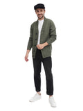 Full body shot man in black flat cap with olive bomber jacket white tee and dark jeans