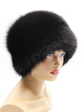 Black fox fur hat from the right side, rounded crown sitting low over the ear