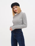 Woman wearing black linen Breton cap looking sideways in grey sweater