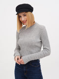 Woman wearing black linen Breton cap with grey ribbed sweater, smiling