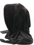 Three-quarter back view black mink fur hat hood with jersey shawl draped across shoulders showing mink pompon