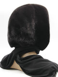 Detail view black knit shawl edge of mink fur hat hood showing plain fabric end without pompons
