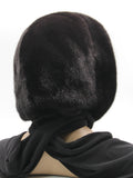Three-quarter back view black mink fur hat hood with wide black knit shawl draped across shoulders