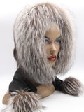 Black mink fur hood scarf wrap with silver fox trim and pompons on female model, front view