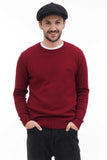 Full body shot man in black wool newsboy cap with burgundy sweater and dark jeans