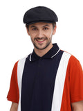 Man in black cotton flat cap close-up torso view with colorblock polo shirt front angle