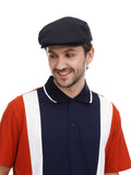 Man in black flat cap torso view front angle with navy orange polo shirt casual pose