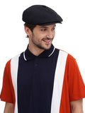 Man in black 8-panel flat cap upper body side angle view with colorblock polo shirt