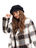 Close-up of woman in black 8-panel paperboy cap showing crown structure