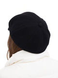 Black wool 8-panel baker boy cap front view on white background