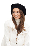 Three-quarter view of woman in black wool baker boy hat white background