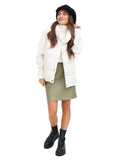 Woman in black wool newsboy cap with green skirt and black boots full body