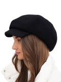 Side profile of woman in black wool 8-panel newsboy cap