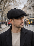 Man wearing black wool newsboy hat beige coat street