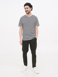 an wearing black wrinkled linen newsboy cap striped shirt