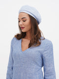 Blue linen beret back view showing flat crown drape and long hair with blue dress combination