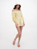Woman wearing bright white cotton bucket cloche hat with yellow floral dress