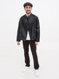 Man wearing brown wrinkled linen newsboy cap full body black outfit