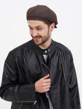 Man wearing brown linen newsboy cap side view black leather jacket