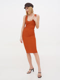 Side angle of woman wearing brown linen newsboy cap with terracotta dress