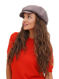 Front portrait of woman in cappuccino brown 8-panel newsboy cap and red top