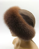 Side view of brown suede top and arctic fox band on a round women’s hat