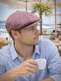Burgundy baker boy cap mens lifestyle summer city setting