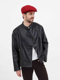 Three quarter angle man wearing burgundy linen 8-panel newsboy cap with black leather jacket