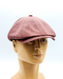 Burgundy linen newsboy cap side angle on mannequin
